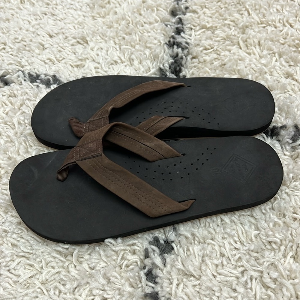 Brand new Reef flip flops on dark brown